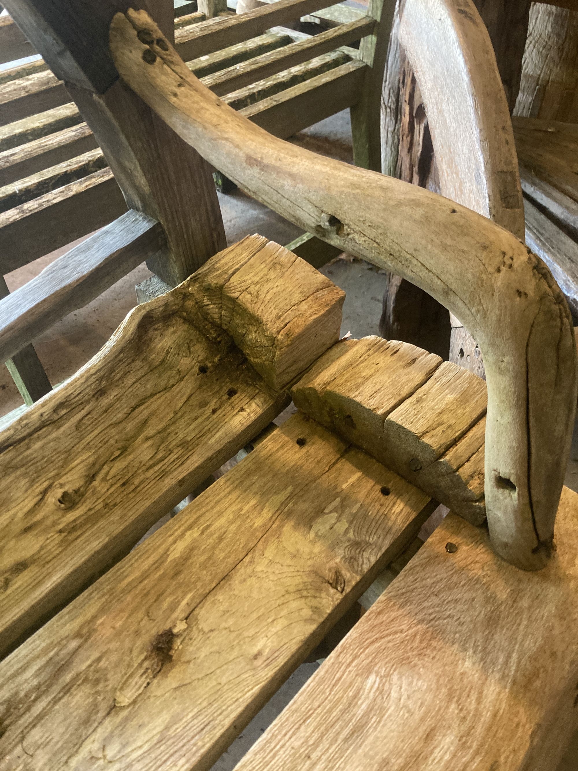 A weathered hardwood cartwheel garden bench, width 140cm depth 70cm height 116cm